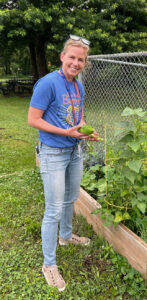 Carrie Lombardi holding vegetables from the Barrett Garden