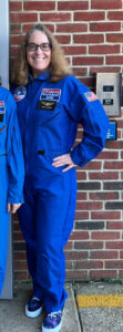 Laurie Sullivan wearing astronaut flight suit during Morning Duty at school