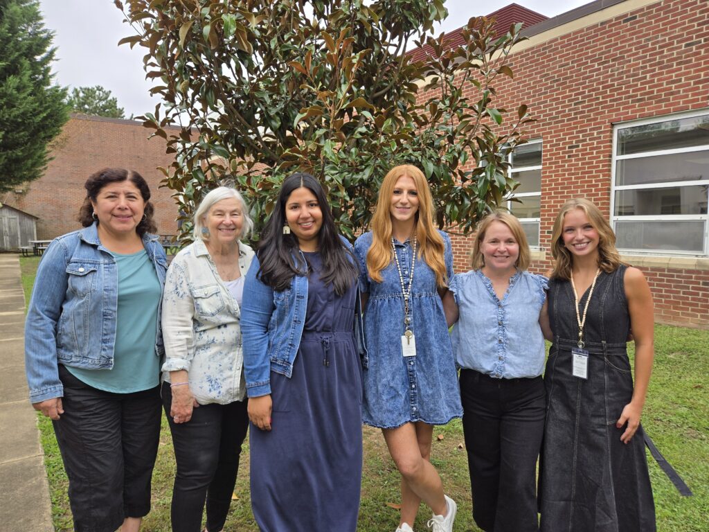 First Grade Teachers pose in the Outdoor Courtyard