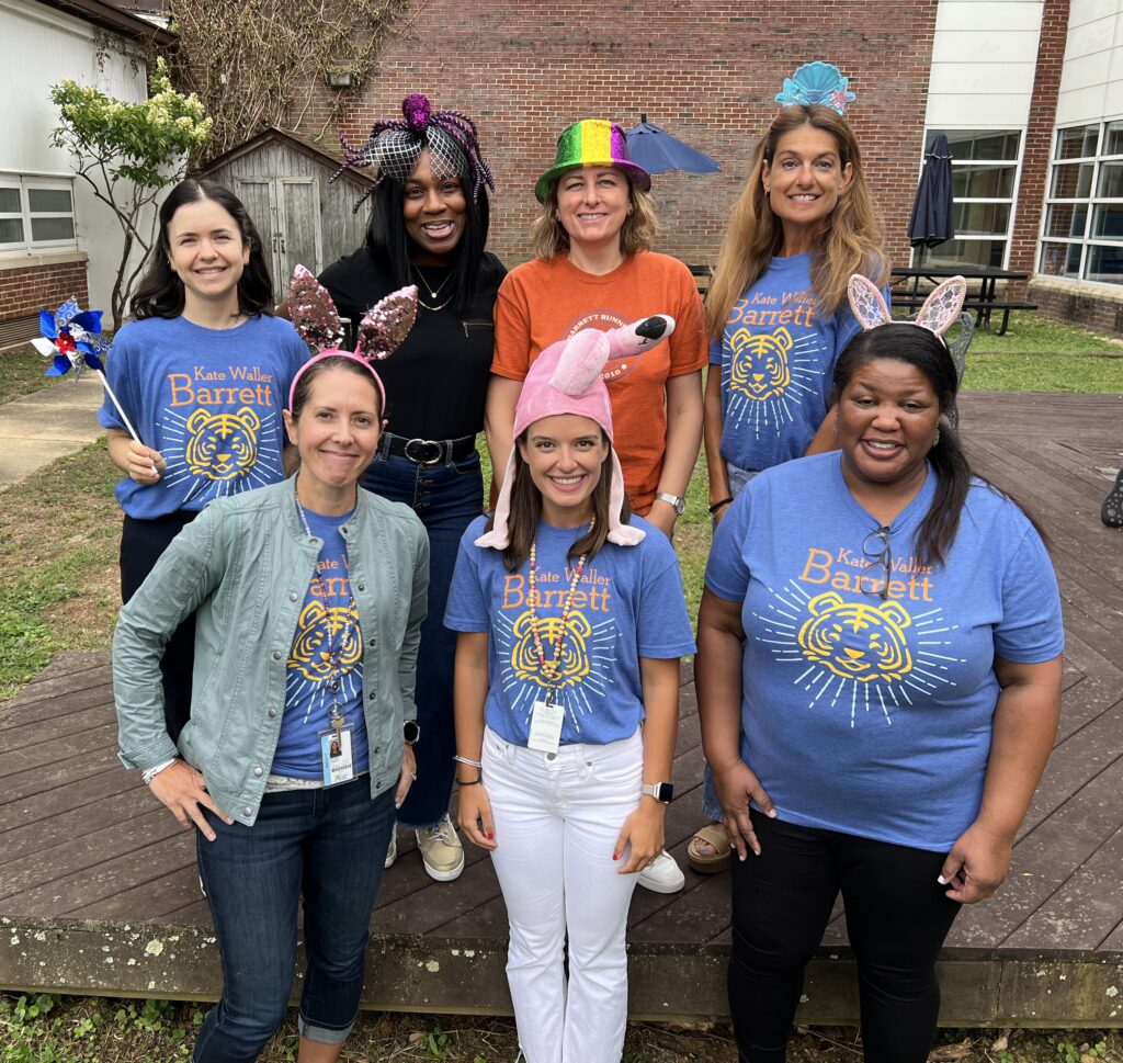 Teachers pose in a group in the Outdoor Courtyard