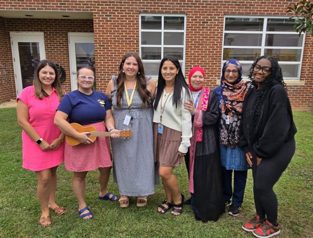 5th grade teachers pose in the Outdoor Courtyard