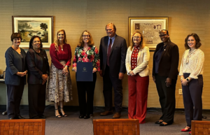 Sullivan holding PAEMST certificate standing with the Virginia Board of Education in Richmond